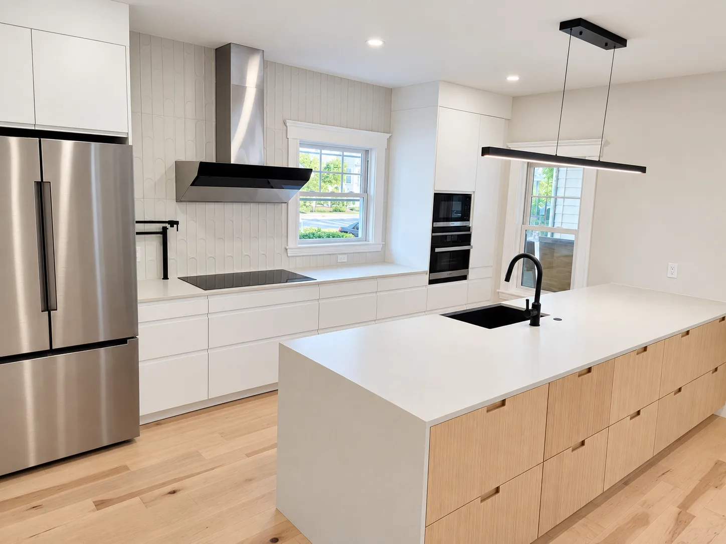 Renovated kitchen with white oak waterfall island
